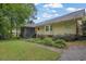 Backyard view featuring lawn, mature landscaping, a screened porch, and a home exterior at 5309 Ashley Se Dr, Conyers, GA 30094