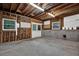 Unfinished basement featuring concrete flooring, wooden framing, windows, and double doors at 5309 Ashley Se Dr, Conyers, GA 30094