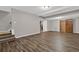 Finished basement with wood-look floors, open layout, and exposed ceiling beams for spacious living at 5309 Ashley Se Dr, Conyers, GA 30094