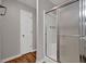 Modern bathroom features a glass-enclosed shower and wood-look flooring at 5309 Ashley Se Dr, Conyers, GA 30094