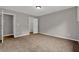 This bedroom features neutral paint and carpet, with a closet and ensuite bathroom at 5309 Ashley Se Dr, Conyers, GA 30094