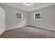Cozy bedroom with carpet, two windows, and neutral walls at 5309 Ashley Se Dr, Conyers, GA 30094