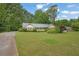 Ranch-style home with large front yard, mature trees, and inviting curb appeal at 5309 Ashley Se Dr, Conyers, GA 30094
