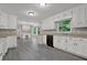Spacious kitchen with white cabinets and built-in workstation adjacent to a sunlit window at 5309 Ashley Se Dr, Conyers, GA 30094