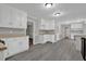 Bright, open kitchen featuring white cabinets, gray flooring, and plenty of workspace at 5309 Ashley Se Dr, Conyers, GA 30094