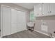 This laundry room features a utility sink, storage cabinets, and hookups for a washer and dryer at 5309 Ashley Se Dr, Conyers, GA 30094