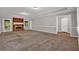 Spacious living room with a cozy brick fireplace and neutral carpet at 5309 Ashley Se Dr, Conyers, GA 30094