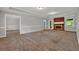 Bright living room with a brick fireplace, carpet flooring, and fresh neutral colors at 5309 Ashley Se Dr, Conyers, GA 30094