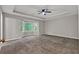 Spacious bedroom boasts a tray ceiling, ceiling fan, and bay windows at 5309 Ashley Se Dr, Conyers, GA 30094