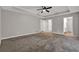 Large bedroom with neutral walls, a ceiling fan, carpet, and closet space at 5309 Ashley Se Dr, Conyers, GA 30094