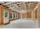 Spacious unfinished basement reveals exposed ceiling and walls, a door and multiple windows at 6265 Bellmoore Park Ln, Johns Creek, GA 30097
