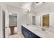 This bathroom features a double sink vanity with solid surface countertops and modern fixtures at 6265 Bellmoore Park Ln, Johns Creek, GA 30097