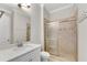Modern bathroom with a shower featuring tiled walls and a vanity with a quartz countertop at 6265 Bellmoore Park Ln, Johns Creek, GA 30097