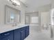 Bathroom featuring a modern vanity, lots of counter space, tub, and shower at 6265 Bellmoore Park Ln, Johns Creek, GA 30097
