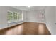 This bright bedroom features hardwood floors and natural light at 6265 Bellmoore Park Ln, Johns Creek, GA 30097
