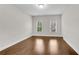 This bedroom features multiple windows and hardwood floors at 6265 Bellmoore Park Ln, Johns Creek, GA 30097