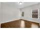 Cozy bedroom with two large windows and hardwood floors at 6265 Bellmoore Park Ln, Johns Creek, GA 30097