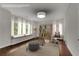 This staged bedroom features natural light and hardwood floors at 6265 Bellmoore Park Ln, Johns Creek, GA 30097
