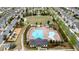 Aerial view of a community pool, playground, and seating areas among the homes at 6265 Bellmoore Park Ln, Johns Creek, GA 30097