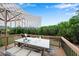 Staged deck with outdoor table set, seating, and umbrella to highlight outdoor living at 6265 Bellmoore Park Ln, Johns Creek, GA 30097