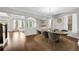 Elegant dining room with hardwood floors, modern chandelier, and open layout for seamless entertaining at 6265 Bellmoore Park Ln, Johns Creek, GA 30097