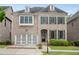 Charming two-story brick home with a well-manicured lawn and attached two-car garage at 6265 Bellmoore Park Ln, Johns Creek, GA 30097