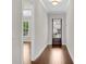 Bright hallway featuring hardwood floors and trim, leading to the front entrance at 6265 Bellmoore Park Ln, Johns Creek, GA 30097