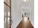 Inviting hallway featuring hardwood floors and elegant trim, leading to various rooms at 6265 Bellmoore Park Ln, Johns Creek, GA 30097