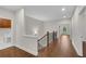 Second floor hallway with hardwood floors and an adjacent laundry area and view of backyard at 6265 Bellmoore Park Ln, Johns Creek, GA 30097