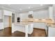 Modern kitchen with a central island, granite countertops, stainless steel appliances, and white cabinetry at 6265 Bellmoore Park Ln, Johns Creek, GA 30097