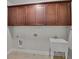 Neat laundry area showcasing cabinets above a utility sink, and convenient hookups at 6265 Bellmoore Park Ln, Johns Creek, GA 30097