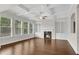Inviting living room with hardwood floors, a fireplace, built-in bookshelves, and coffered ceilings at 6265 Bellmoore Park Ln, Johns Creek, GA 30097