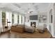 Bright living room featuring coffered ceilings, a fireplace, built-in bookshelves, and large windows at 6265 Bellmoore Park Ln, Johns Creek, GA 30097