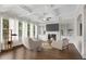 Bright living room featuring a fireplace, built-in bookshelves, and large windows with sheer curtains at 6265 Bellmoore Park Ln, Johns Creek, GA 30097