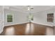 Spacious main bedroom features hardwood floors, tray ceiling, and natural light from many windows at 6265 Bellmoore Park Ln, Johns Creek, GA 30097
