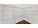 Walk-in pantry boasts wire shelving to maximize storage in the kitchen area of the home at 6265 Bellmoore Park Ln, Johns Creek, GA 30097