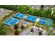 Aerial view showcasing multiple tennis and basketball courts within the community at 6265 Bellmoore Park Ln, Johns Creek, GA 30097