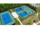 Aerial view showcasing multiple tennis and basketball courts within the community at 6265 Bellmoore Park Ln, Johns Creek, GA 30097