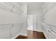 Large walk-in closet with custom storage and lots of light at 6265 Bellmoore Park Ln, Johns Creek, GA 30097