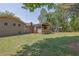 Spacious backyard featuring a covered porch, brick chimney, and lush green lawn at 6470 Windsor Dr, Acworth, GA 30102