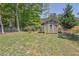 Fenced backyard features a storage shed with a single window, offering practical outdoor space at 6470 Windsor Dr, Acworth, GA 30102