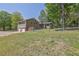 Spacious backyard showing the home's exterior, two-car garage, and outdoor patio at 6470 Windsor Dr, Acworth, GA 30102