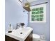 Bathroom featuring a window, wood-look floors, and blue painted walls at 6470 Windsor Dr, Acworth, GA 30102