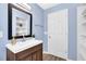Bathroom featuring wood-look floors, shelving, and blue painted walls at 6470 Windsor Dr, Acworth, GA 30102