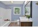 Bathroom featuring a tub, wood-look floors, and blue painted walls at 6470 Windsor Dr, Acworth, GA 30102