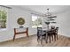 Inviting dining area with modern lighting, table, and natural light from large windows at 6470 Windsor Dr, Acworth, GA 30102