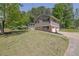 Traditional home with lush green lawn, features a two-car garage and covered front porch at 6470 Windsor Dr, Acworth, GA 30102