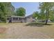 Well-maintained home with large front yard, a covered entry, and plenty of shade from mature trees at 6470 Windsor Dr, Acworth, GA 30102