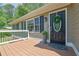 A charming front porch welcomes you with a stylish front door, a wreath, and a pot with a decorative plant at 6470 Windsor Dr, Acworth, GA 30102
