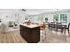 Bright kitchen and dining area with an island, stainless steel appliances, and an open floor plan at 6470 Windsor Dr, Acworth, GA 30102